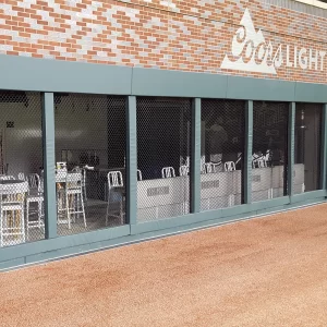 green chain link post & rail padding installed in front of food court by ball field